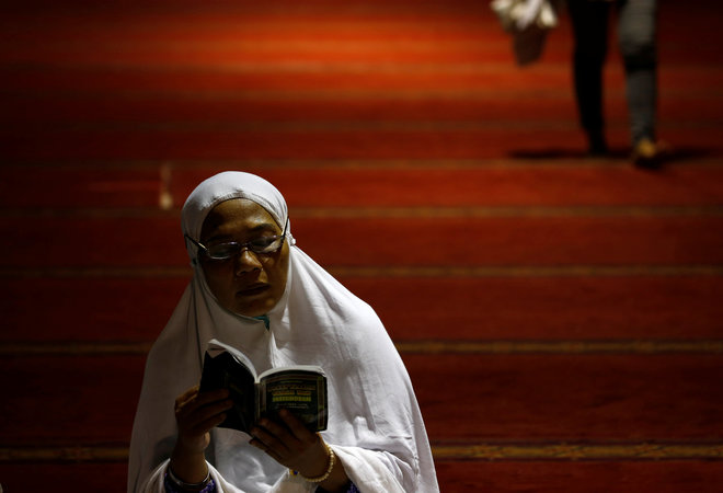 A Muslim woman reads the Koran during the first day of the holy fasting month of Ramadan at Istiqlal mosque in Jakarta, Indonesia, June 6.