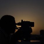 A Pakistani Muslim looks through binoculars in order to sight the moon in the Pakistani port city of Karachi on June 6.