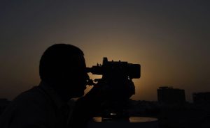 A Pakistani Muslim looks through binoculars in order to sight the moon in the Pakistani port city of Karachi on June 6.