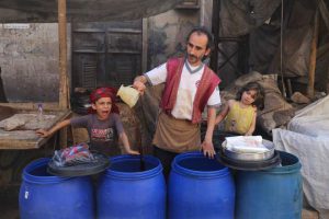 A Syrian man sells the traditional licorice root drink in the reble-held district of al-Fardous in the northern city of Aleppo on June 6, as people shop prior to Iftar, or breaking of the daylong fast, on the first day of the holy month of Ramadan.