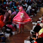 A child walks between Muslim women waiting to break the fast during the holy month of Ramadan inside Istiqlal mosque in Jakarta, Indonesia June 6.