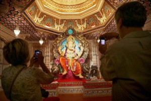 A foreign tourist clicks photo of a Ganesh idol installed at pandal for Ganesh festival in Mumbai on September 15, 2015