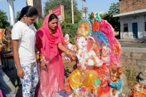 A girl and a woman purchase an idol of Lord Ganesha for the Ganesh festival in Jodhpur, Rajasthan, on September 15, 2015
