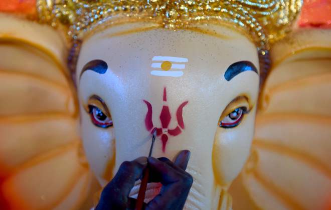 A labourer gives the finishing touches to a statue of Lord Ganesha ahead of the Ganesh Chaturthi festival at a workshop in Chennai on August 28