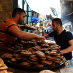 A man arranges sweet bread on the first day of the holy fasting month of Ramadan in Tripoli, Lebanon June 6.