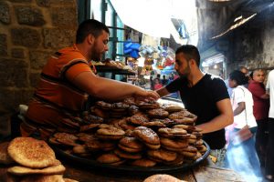 A man arranges sweet bread on the first day of the holy fasting month of Ramadan in Tripoli, Lebanon June 6.