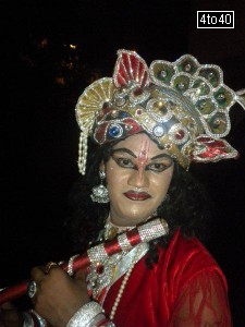 A professional artist dressed as Lord Krishna on the eve of Janmashtami at Vidya Vihar Apartments, Sector 9, Rohini, New Delhi