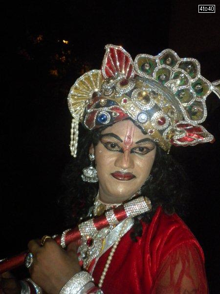 A professional artist dressed as Lord Krishna on the eve of Janmashtami at Vidya Vihar Apartments, Sector 9, Rohini, New Delhi