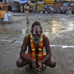 A sadhu or a Hindu holy man waits to take a holy dip in the waters of Godavari river during the second ‘Shahi Snan’ (grand bath) at the Kumbh Mela or Pitcher Festival in Nashik on September 13, 2015