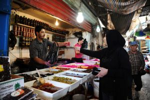 A woman pays after buying pickled produce on the first day of the holy fasting month of Ramadan in Tripoli, Lebanon June 6.