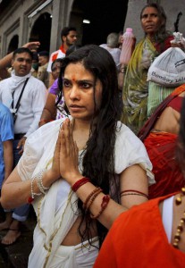 A woman prays after taking holy in Godavari during the second ‘Shahi Snan’ (grand bath) during the Kumbh Mela, or Pitcher Festival, in Nashik on September 13, 2015