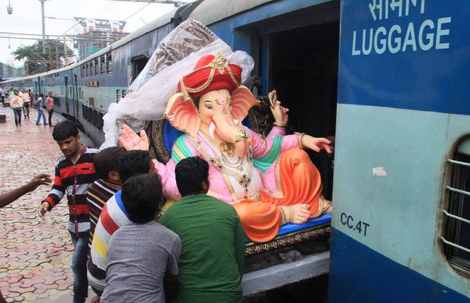 An Idol of Lord Ganesha being boarded into a train in Mumbai