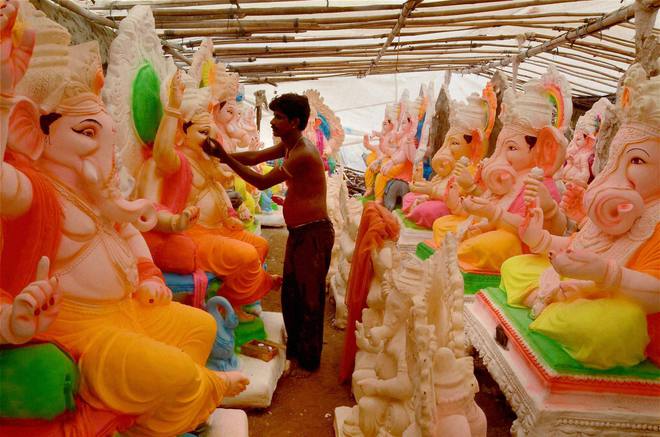 An artist giving touches to an idol of Lord Ganesh ahead of Ganesh festival in Jodhpur