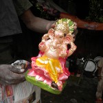 Artist displays freshly painted statue of Lord Ganesha at Deepali Chowk, Rohini, New Delhi