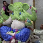 Artists gives finishing touches to the idol of Lord Ganapati made of Mentos Chocolates, ahead of Ganesh festival in Mumbai