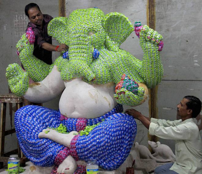 Artists gives finishing touches to the idol of Lord Ganapati made of Mentos Chocolates, ahead of Ganesh festival in Mumbai