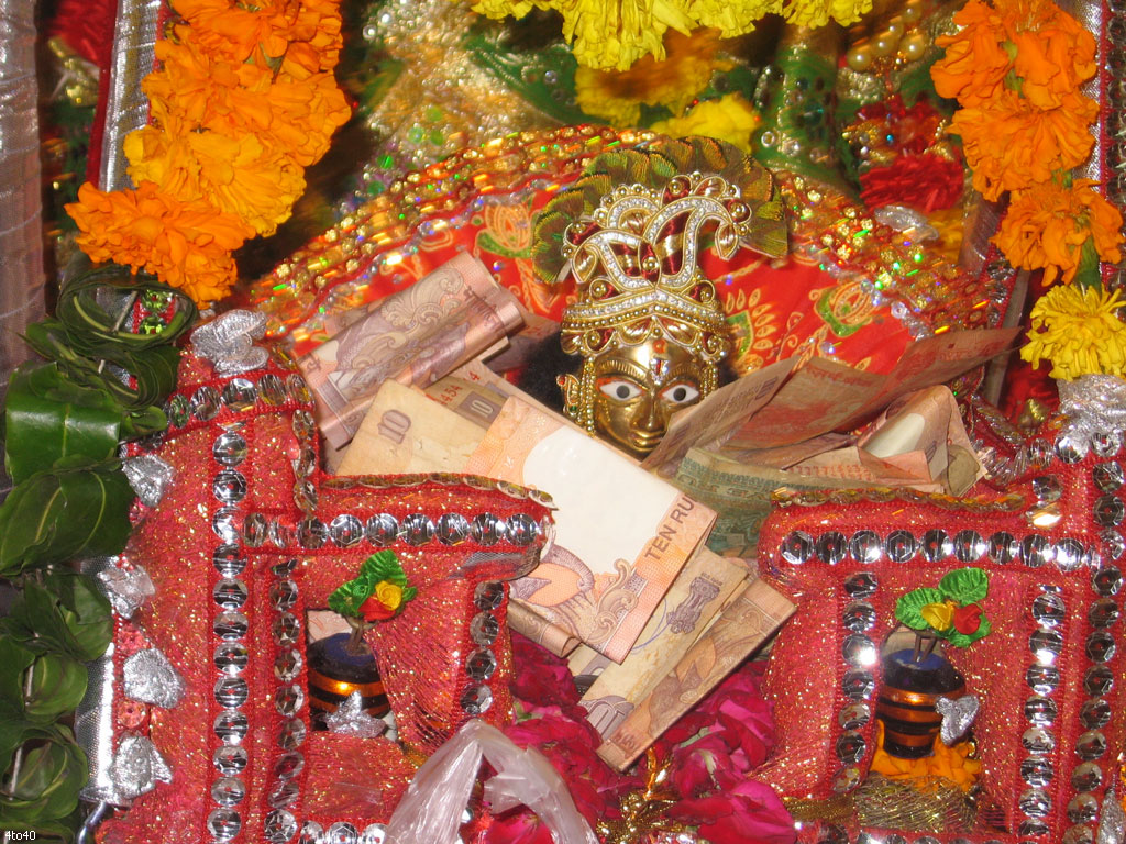 Bal Krishna idol is decorated in a cradle on occassion of Janmashtami