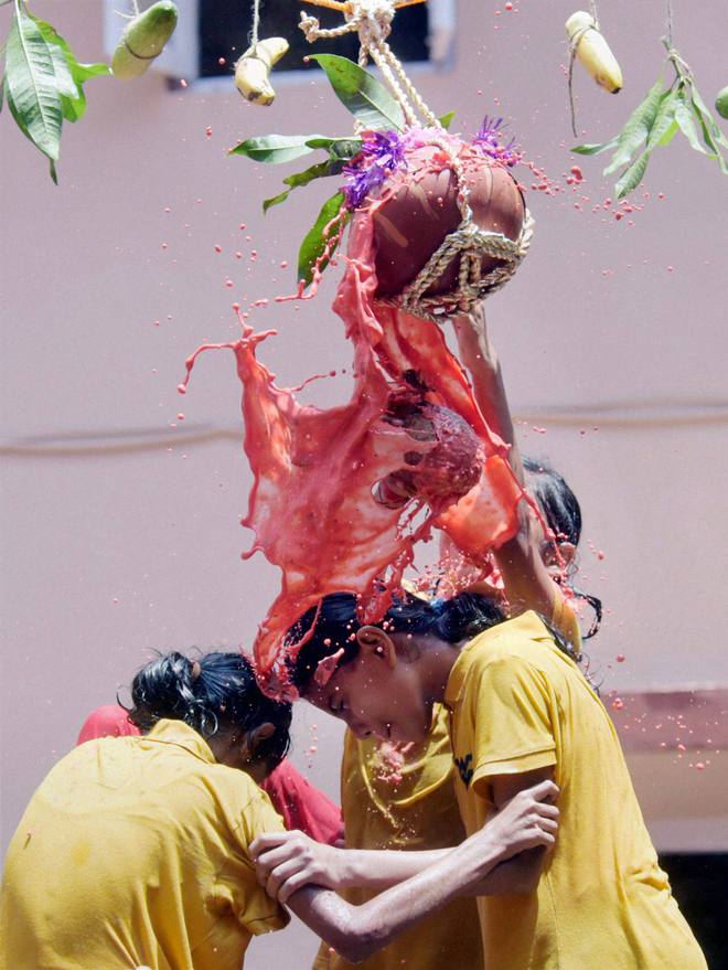 Blind students form a pyramid to break a pot of curds tied high up with a string in a ritual called Dahi Handi as part of Janmasthami celebrations in Mumbai on September 5, 2015. Janmasthami marks the birth anniversary of Hindu Lord Krishna. ‘Dahi Handi’ is a ritual observed primarily in Maharashtra