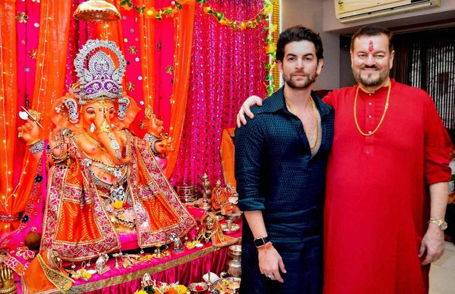 Bollywood actor Neil Nitin Mukesh (left) and his father, singer Nitin Mukesh, during the Ganesh festival at their house in Mumbai on September 18, 2015