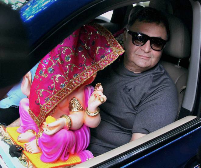 Bollywood actor Rishi Kapoor carries a statue of the elephant-headed Hindu god Lord Ganesh during the Ganesh festival in Mumbai on September 18, 2015