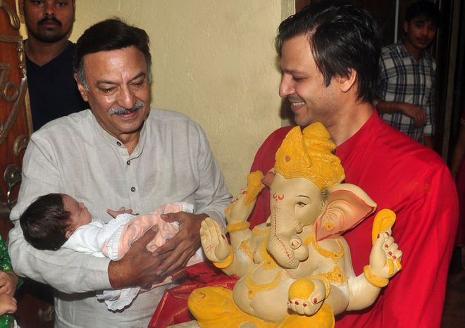 Bollywood actor Suresh Oberoi (left) and his son Vivek Oberoi offers prayers to a statue of the elephant-headed Hindu god Lord Ganesh to mark the Hindu festival Ganesh Chaturthi in Mumbai on September 17, 2015