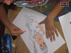 Children coloring a sketch of Lord Ganesha