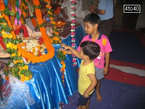 Children giving swing to Balkrishna idol on eve of Janmashtami Festival