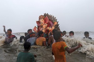 Devotees carry an idol of the Hindu elephant god Lord Ganesh into the Arabian Sea
