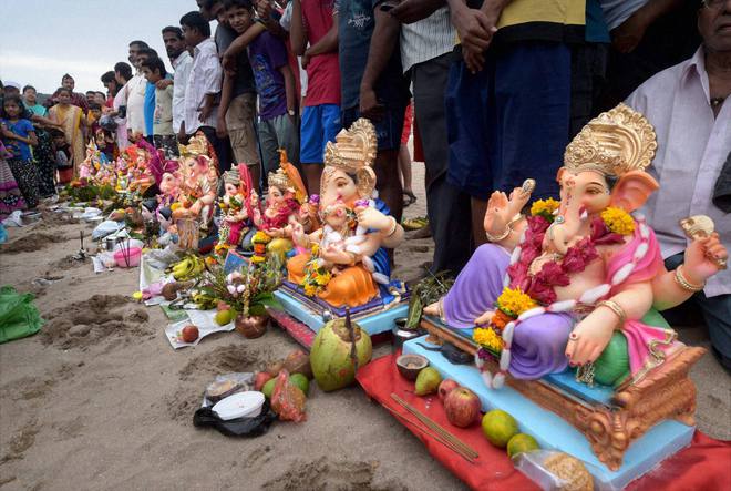 Devotees pray to an idol of the Hindu elephant god Lord Ganesh before immersing them in Mumbai