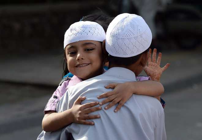 Muslim children greet each other during the festival of Eid al-Adha in New Delhi on September 25, 2015