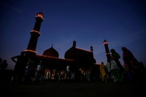 Muslim women walk at the Jama Masjid (Grand Mosque) after spotting the crescent moon in the sky, on the eve of the holy fasting month of Ramadan, in the old quarters of Delhi, June 6.