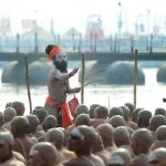 Newly initiated Naga Sadhus (Hindu holy men) sit as they perform rituals on the banks of the Ganges river during the Kumbh Mela, in Allahabad.