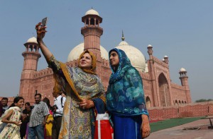 Pakistani women takes a selfie with relative after offering Eid al-Adha prays at the Badshahi Mosque in Lahore on September 25, 2015