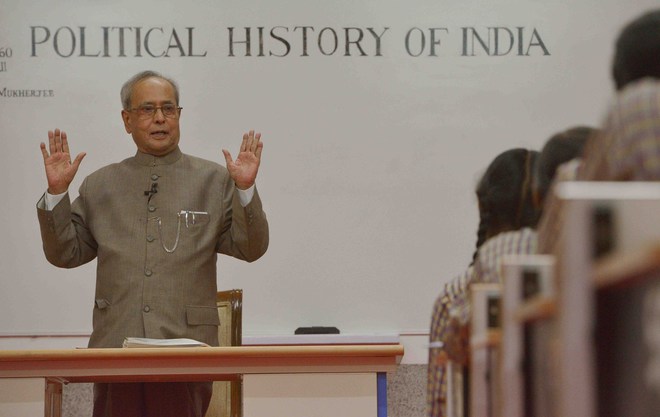 President Pranab Mukherjee teaches students at a government school to mark Teachers’ Day in New Delhi on Septmber 5, 2015