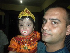 Proud father with his kid dressed as Bal Krishna