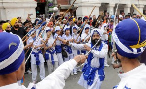 Sikh devotees display their Gatka skills — a form of Sikh martial art — during a religious procession, a Nagar Kirtan, from Gurdwara Sis Ganj Sahib on the eve of the birth anniversary of Guru Nanak Dev