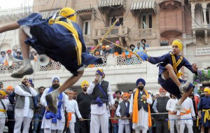 Sikh devotees display their Gatka skills — a form of Sikh martial art — during a religious procession, a Nagar Kirtan, from Gurdwara Sis Ganj Sahib on the eve of the birth anniversary of Guru Nanak Dev.