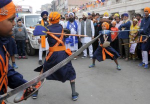 Sikh devotees display their Gatka skills — a form of Sikh martial art — during a religious procession, a Nagar Kirtan, from Gurdwara Sis Ganj Sahib on the eve of the birth anniversary of Guru Nanak Dev