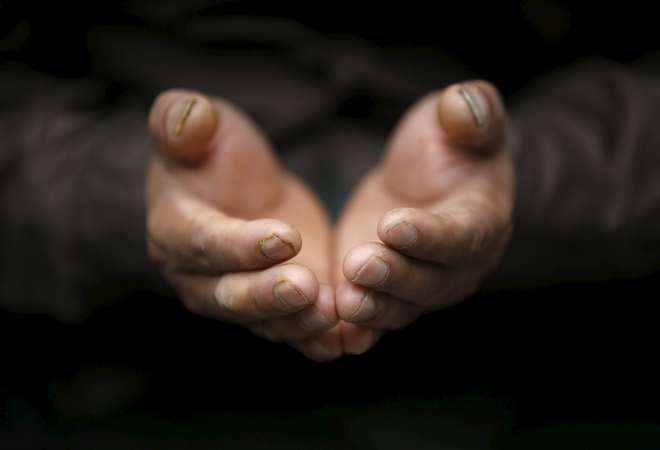 The hands of a Muslim man are pictured as he offers prayers during the Eid al-Adha celebrations at the Kashmiri Takiya Jame mosque in Kathmandu, Nepal, on September 25, 2015