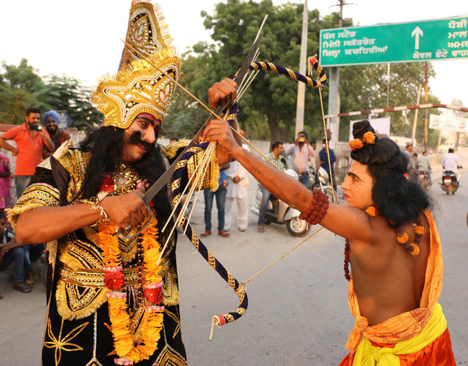 A man dressed as Hindu God Ram and demon king Ravana engage in a mock fight during Dusshera celebrations in Bathinda on October 22, 2015. The celebrations mark the end of the nine-day Navratri festival