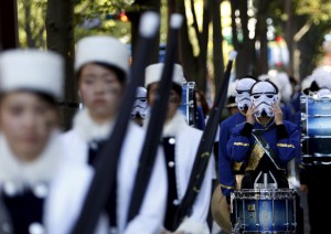 A member of a band puts on a Stormtrooper mask before a Star Wars parade, which is part of a Halloween parade in Kawasaki, south of Tokyo, on October 25, 2015