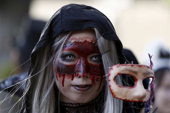A participant in costume poses for a picture during a Halloween parade in Kawasaki, south of Tokyo, on October 25, 2015