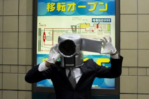A reveller wearing a mask in the shape of a camera poses for pictures during Halloween celebrations in the Shibuya district in Tokyo on October 31, 2015