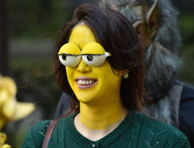 A woman wearing a Simpsons face mask takes part in a Halloween parade on a street in Kawasaki on October 25, 2015