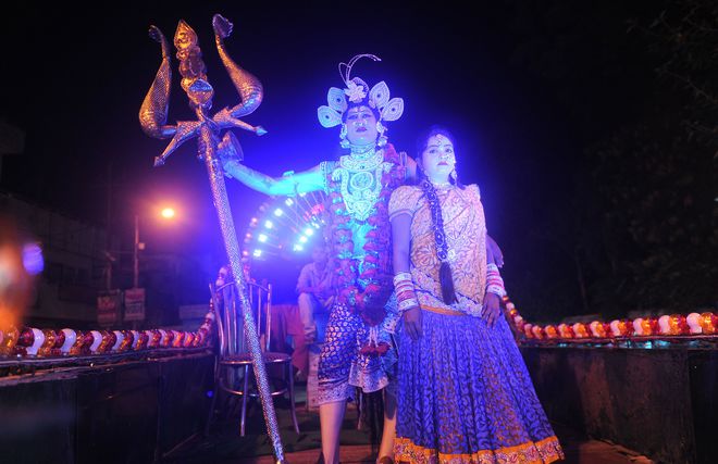 An Indian artist dressed as Hindu god Shiva performs on a chariot as he participates in a religious procession ‘Ravan ki Barat’ held to mark the forthcoming Dussehra festival in Allahabad on September 26, 2016.