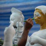 An Indian artist works on a clay idol of the Hindu goddess Durga in preparation for the upcoming Durga Puja festival at a temple in Bangkok on September 21, 2016.