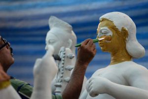 An Indian artist works on a clay idol of the Hindu goddess Durga in preparation for the upcoming Durga Puja festival at a temple in Bangkok on September 21, 2016.