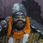 An Indian artiste dressed as demon king Ravana laughs during a religious procession ‘Ravan ki Barat’ in Allahabad on September 26, 2016, held to mark the Dussehra festival.