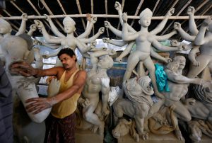 An artisan works on an idol of Hindu Goddess Durga at a workshop ahead of the Durga Puja festival in Kolkata, on September 20, 2016.