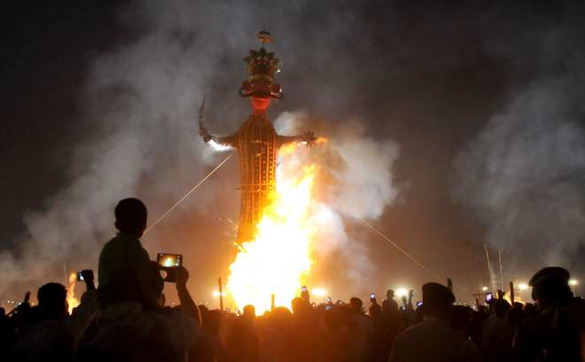 An effigy of demon king Ravana goes up in flames on the occasion of Dussehra in Karnal on October 22, 2015